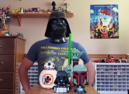 Telford Burtts in a Darth Vader mask with various starwars lego toys in front of him.