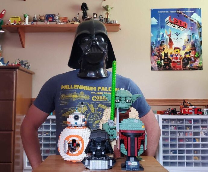 Telford Burtts in a Darth Vader mask with various starwars lego toys in front of him.