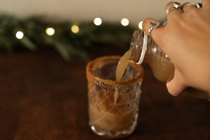 Apple cider being poured into glass