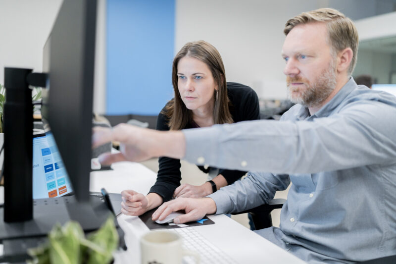 Glen Weiman and Reena Hensley collaborating at a workstation.