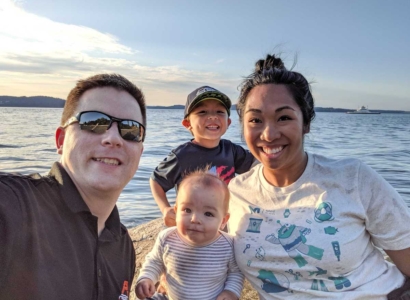 Angie Carson with her husband and kids at the waterfront.