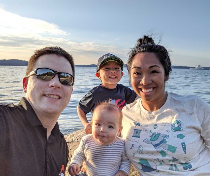 Angie Carson with her husband and kids at the waterfront.