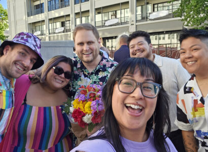 Community members smiling for a group photo