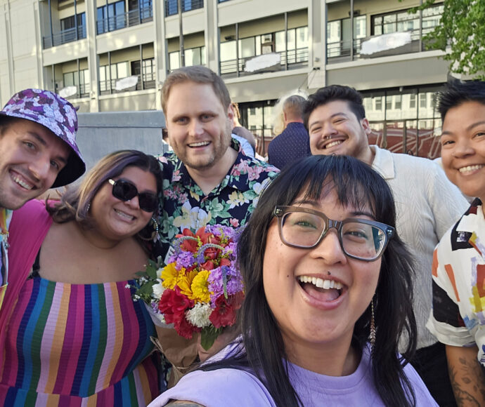Community members smiling for a group photo