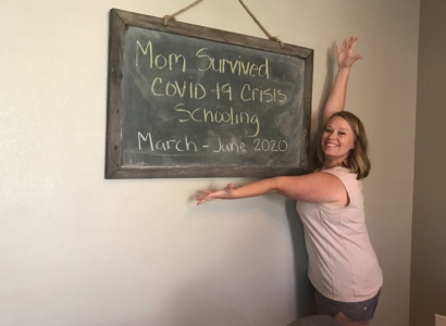 Crissy Pagulayan in front of a chalk board sign that reads Mom survived Covid-19 Crisis Schooling March - June 2020.