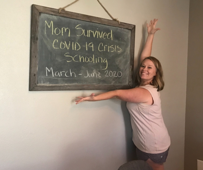 Crissy Pagulayan in front of a chalk board sign that reads Mom survived Covid-19 Crisis Schooling March - June 2020.