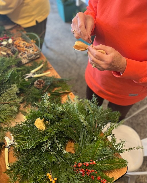 Woman making a fresh winter wreath
