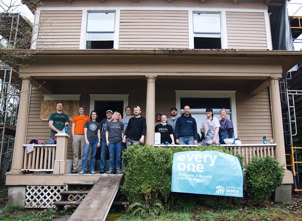 SiteCrafting employees standing in front of a habitat for humanity house