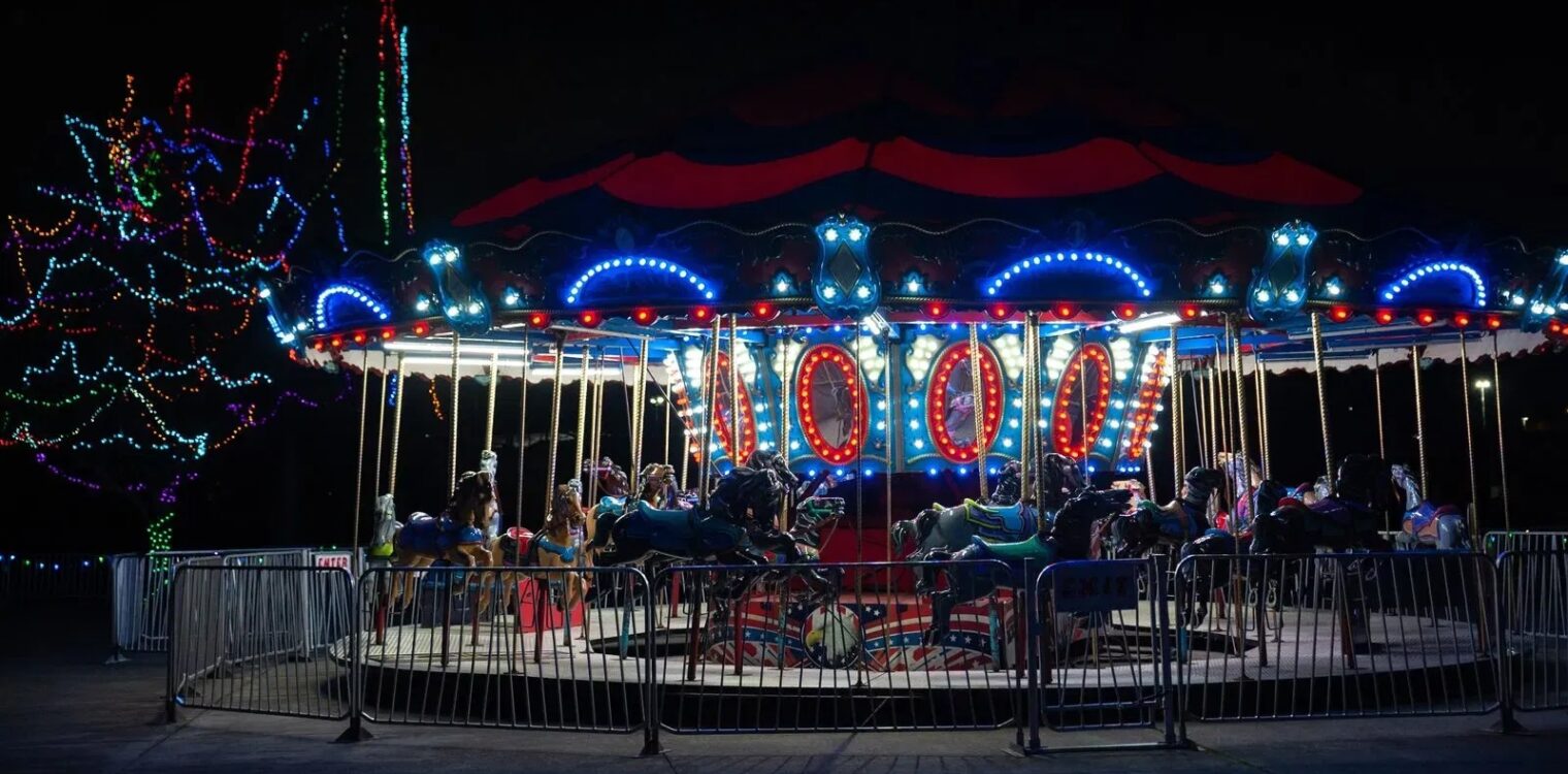 Merry-go-round carousel ride lit up at night