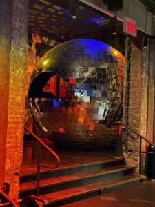 Oversized disco ball with a DJ set inside