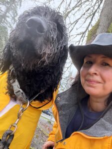 Jen and her dog on the trail in matching yellow rain jackets