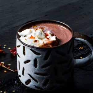 White and black mug filled with hot chocolate and whip cream topping