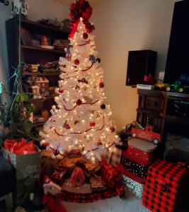 White glowing Christmas tree with red presents