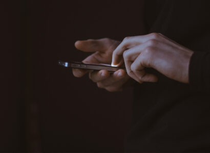Hands interacting with a mobile phone.