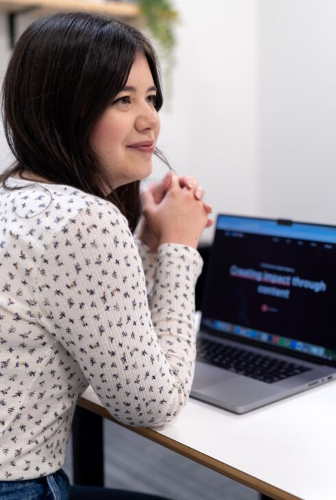 Employee smiling while working with teammates.