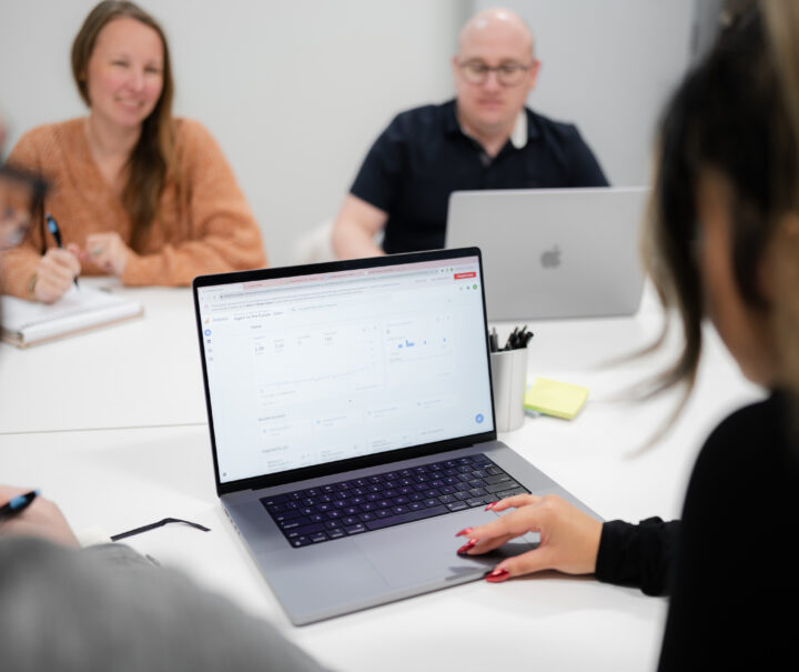 SiteCrafting employees working in a conference room.