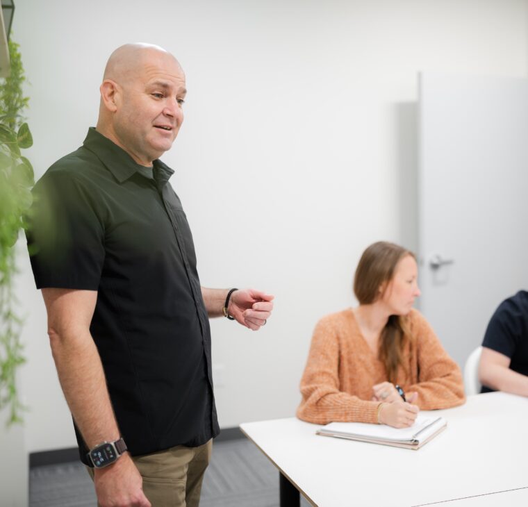 The president of sitecrafting in a meeting with the team.