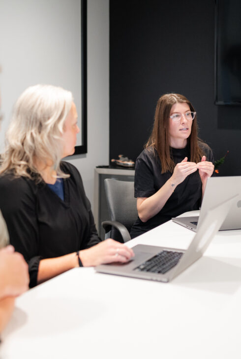 Three project manages talking about consulting.