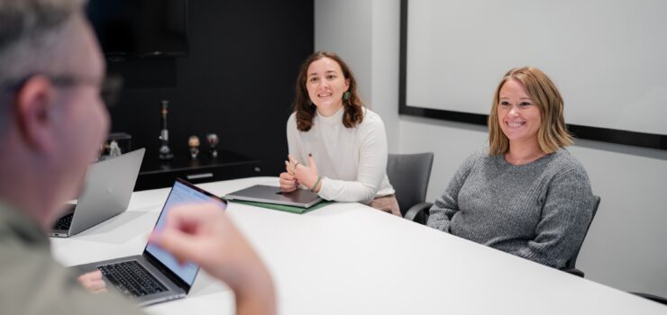 Project managers around a table discussing project plans.