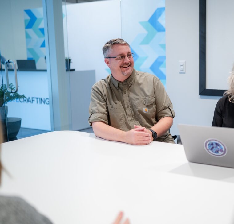Employees in conference room having a conversation.