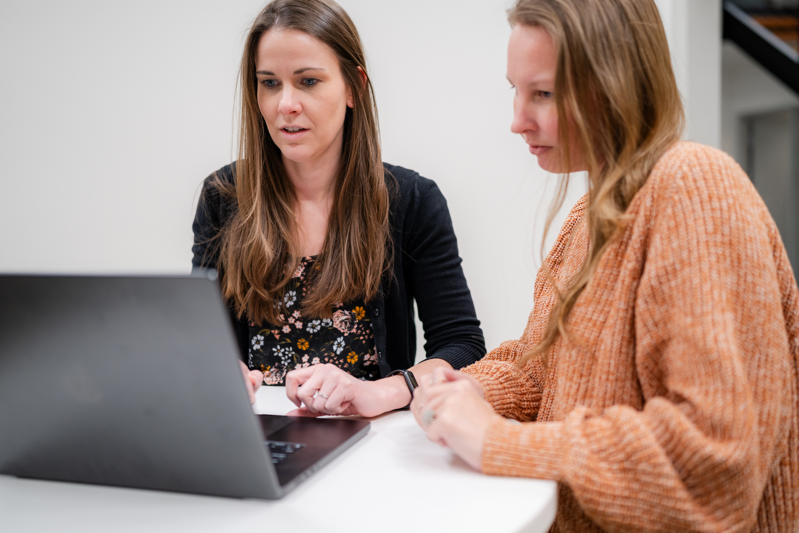 Front-end developers working on a laptop together