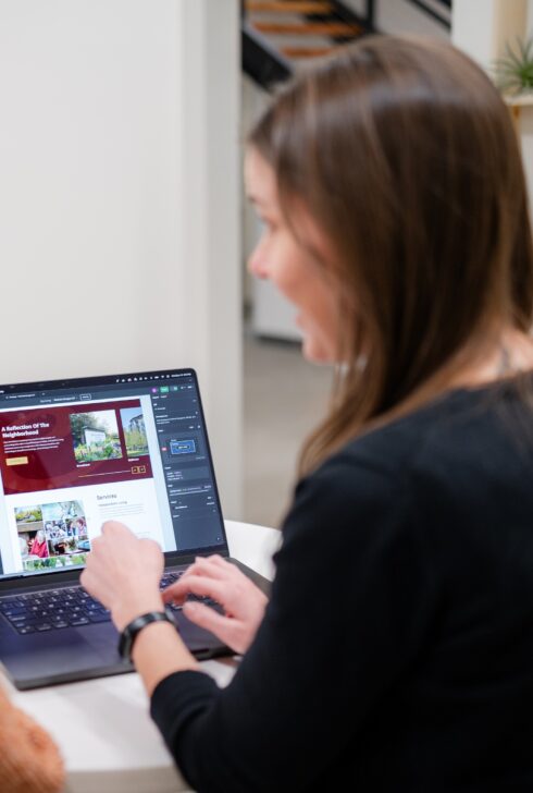 Employees coding on a laptop.