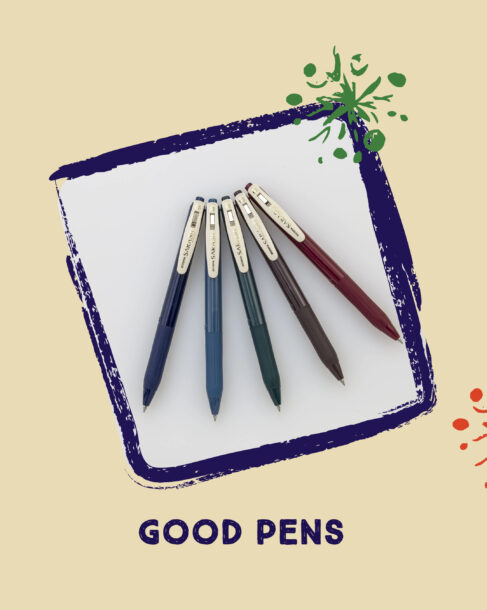 A collection of pens in a fanned arrangement in a frame with a blue border and minimal green and red artistic snowflakes. Below the framed image reads 'Good Pens.'