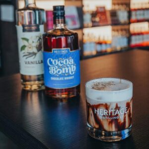 Cocktail glass with bottles of whiskey and vodka