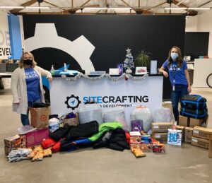 Crissy and Aly at the office with warm clothing donation items