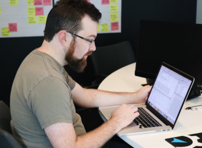 Joe Izenman working at a laptop.