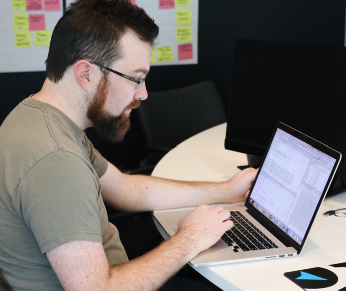 Joe Izenman working at a laptop.