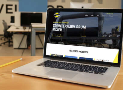 Laptop showing the Aesco Madsen website.