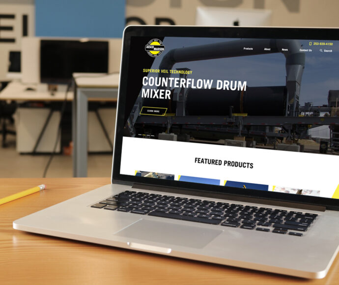 Laptop showing the Aesco Madsen website.