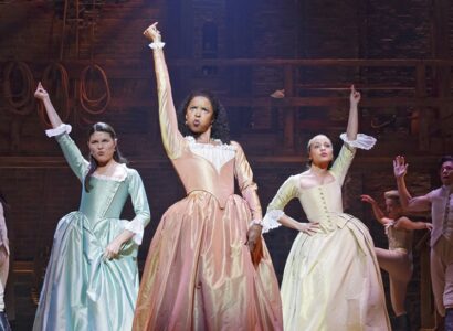 Animated gif of three Hamilton musical cast members standing proud.