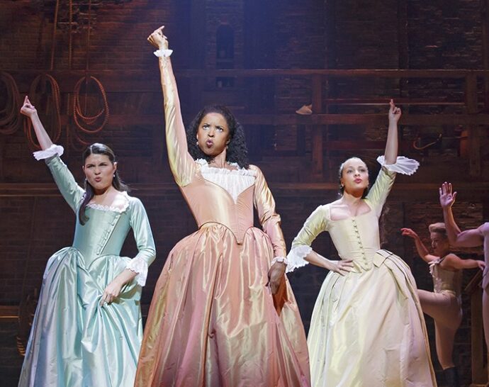 Animated gif of three Hamilton musical cast members standing proud.