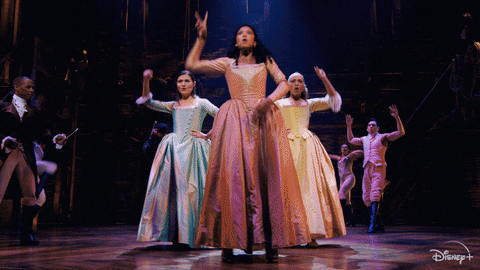 Animated gif of three Hamilton musical cast members cheering.