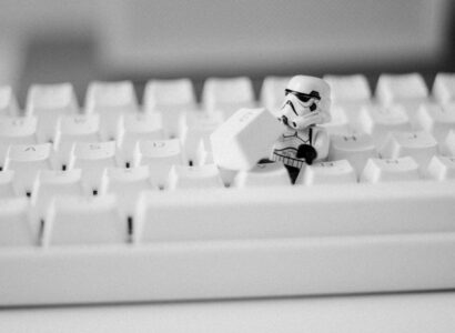Storm trooper mini fig removing the G key from a keyboard.