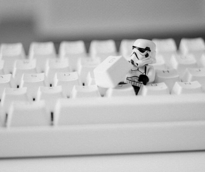 Storm trooper mini fig removing the G key from a keyboard.