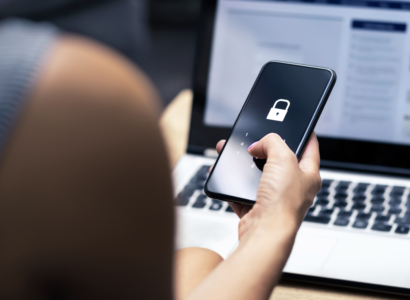 Woman holding a phone with a locked screen