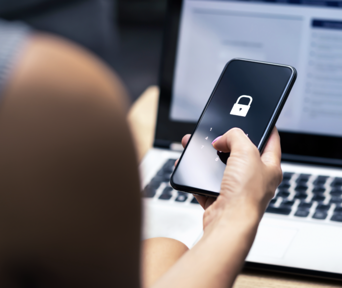 Woman holding a phone with a locked screen