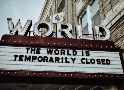 Marquee sign that reads the world is temporarily closed