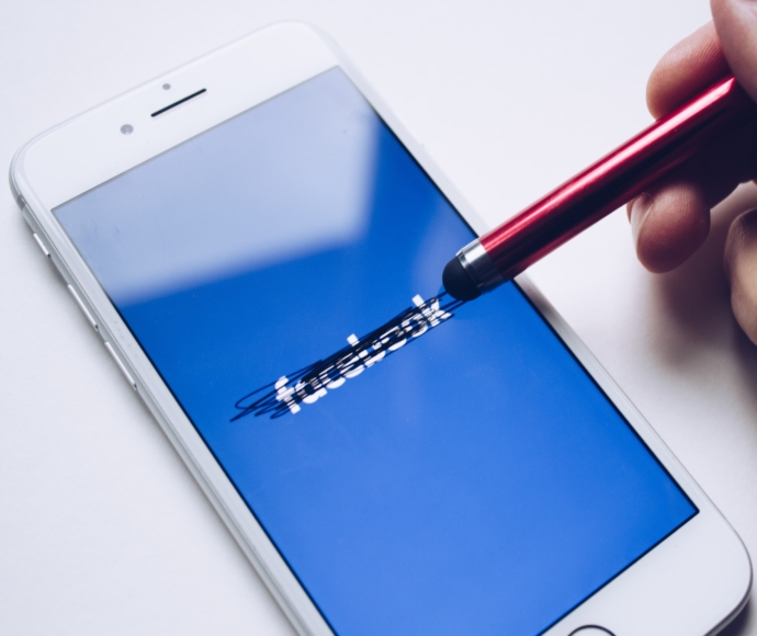 Facebook blacked out on mobile phone screen.