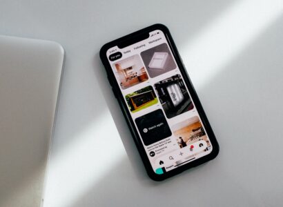 Smart phone sitting on a white counter with the pinterest app open.