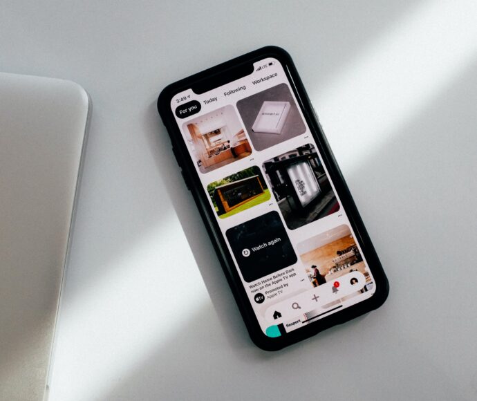 Smart phone sitting on a white counter with the pinterest app open.