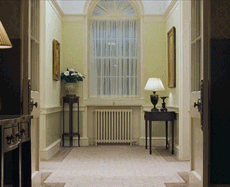 A man dancing/shuffling across the hallway