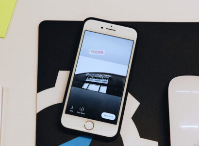 Smart phone with a picture of the SiteCrafting office building on it.