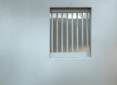 Barred jail cell window.