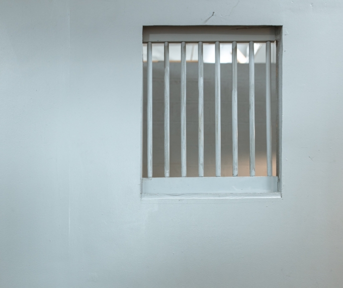 Barred jail cell window.
