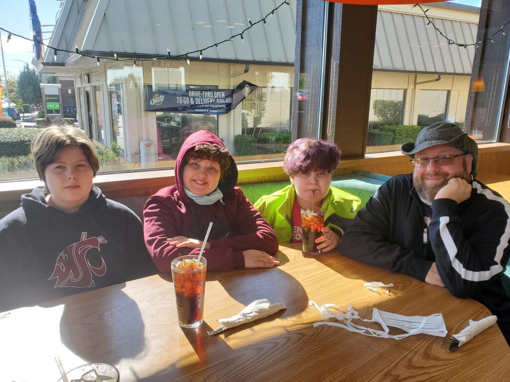 Michelle's family seated at a restaurant table