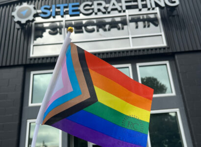 Pride flag in front of SiteCrafting office building